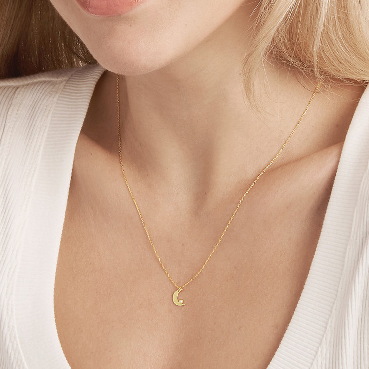 Close-up of My Store diamond bezel half moon necklace with delicate chain and elegant crescent design.