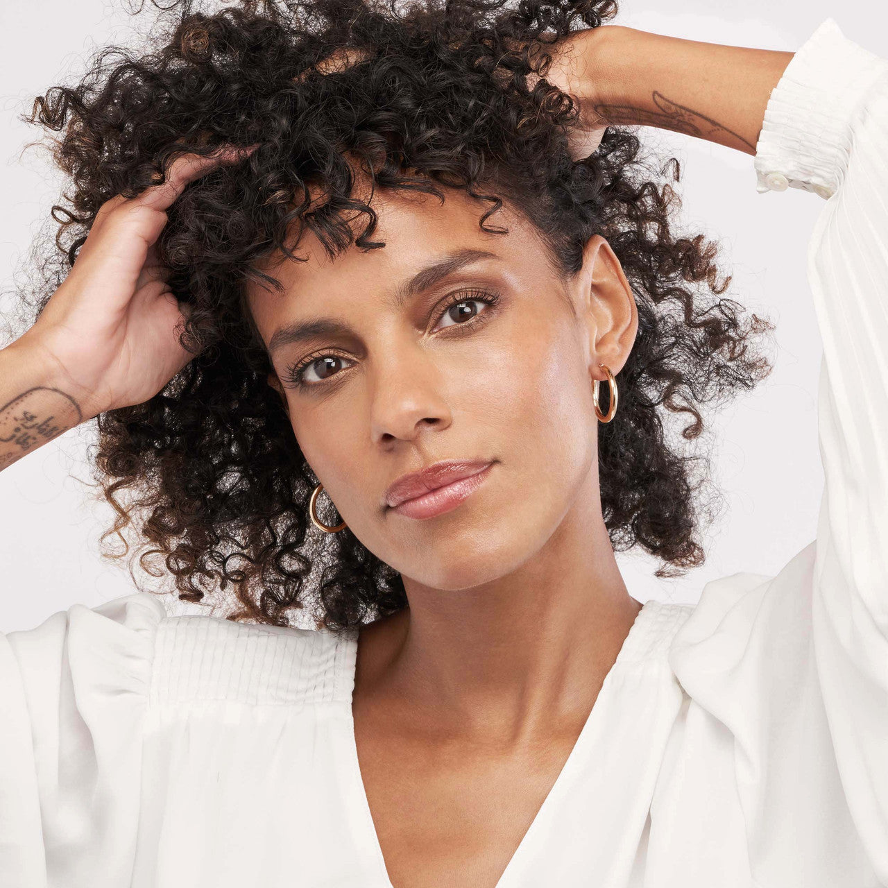 Polished 3mm hoop earrings in a sleek design, showcasing a shiny finish and elegant curves.